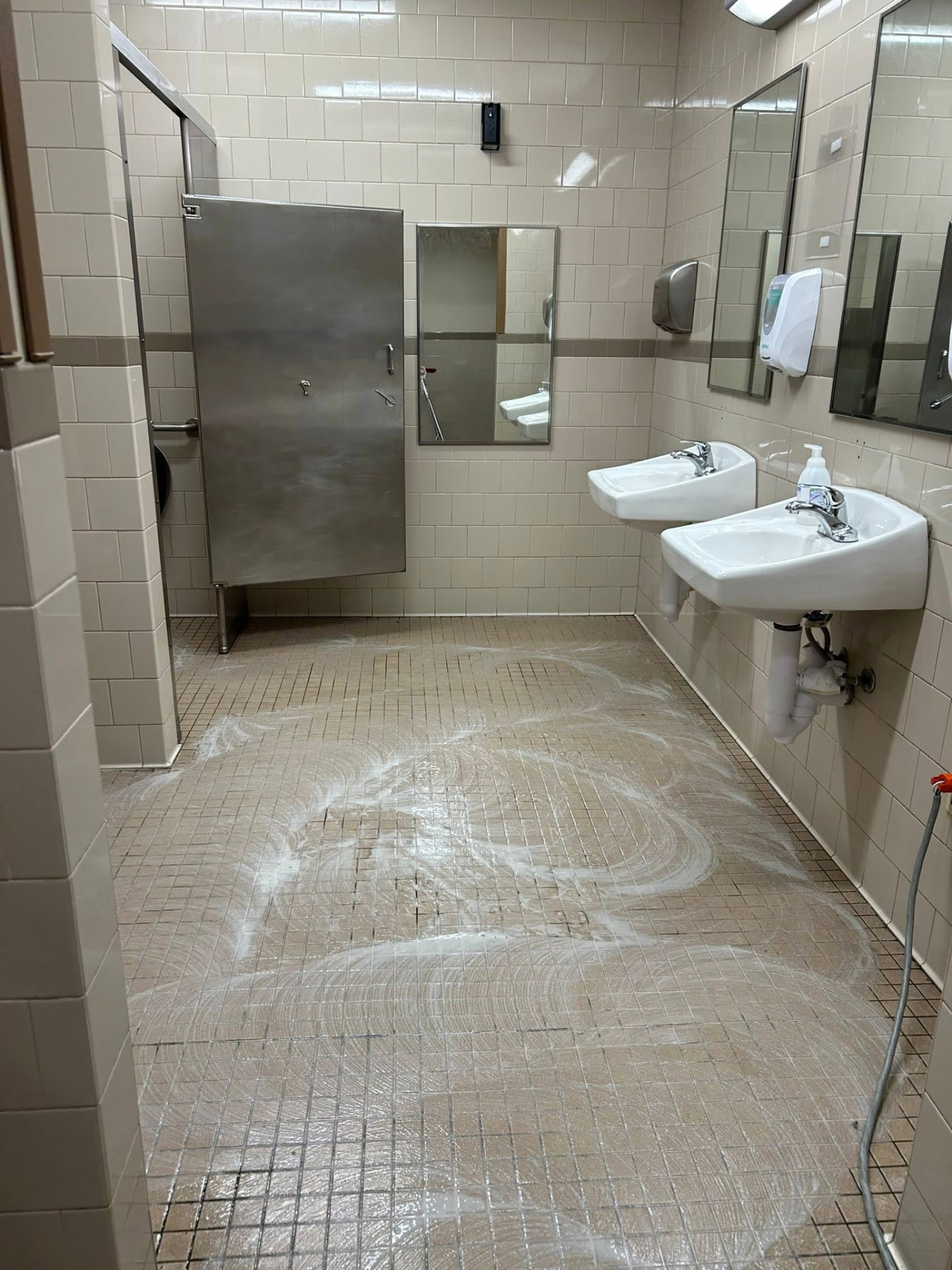 Janitorial professional cleaning a desk in a Baton Rouge commercial office